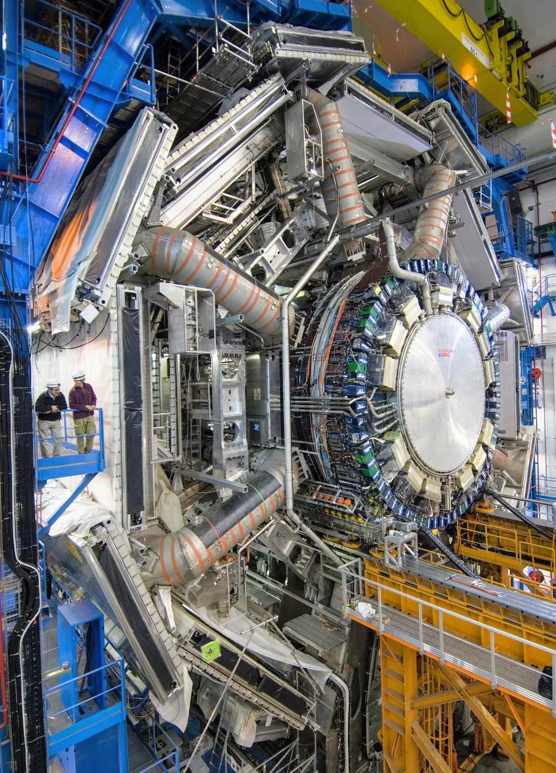 The ATLAS detector assembled with its calorimeter (inner cylinder) that measures the energy of particles. Humans for scale.