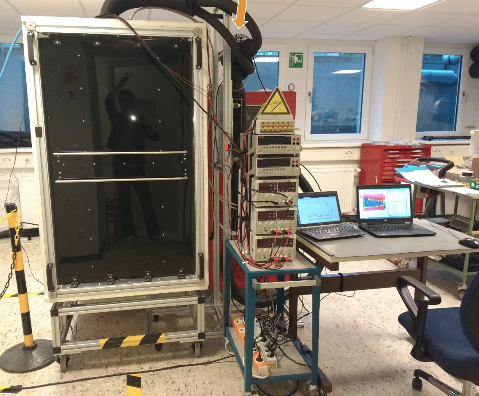 The test chamber and instrumentation devices. The prototype and infrared camera are both inside the dark chamber, shielded from external sources of heat and in a controlled, low humidity environment.