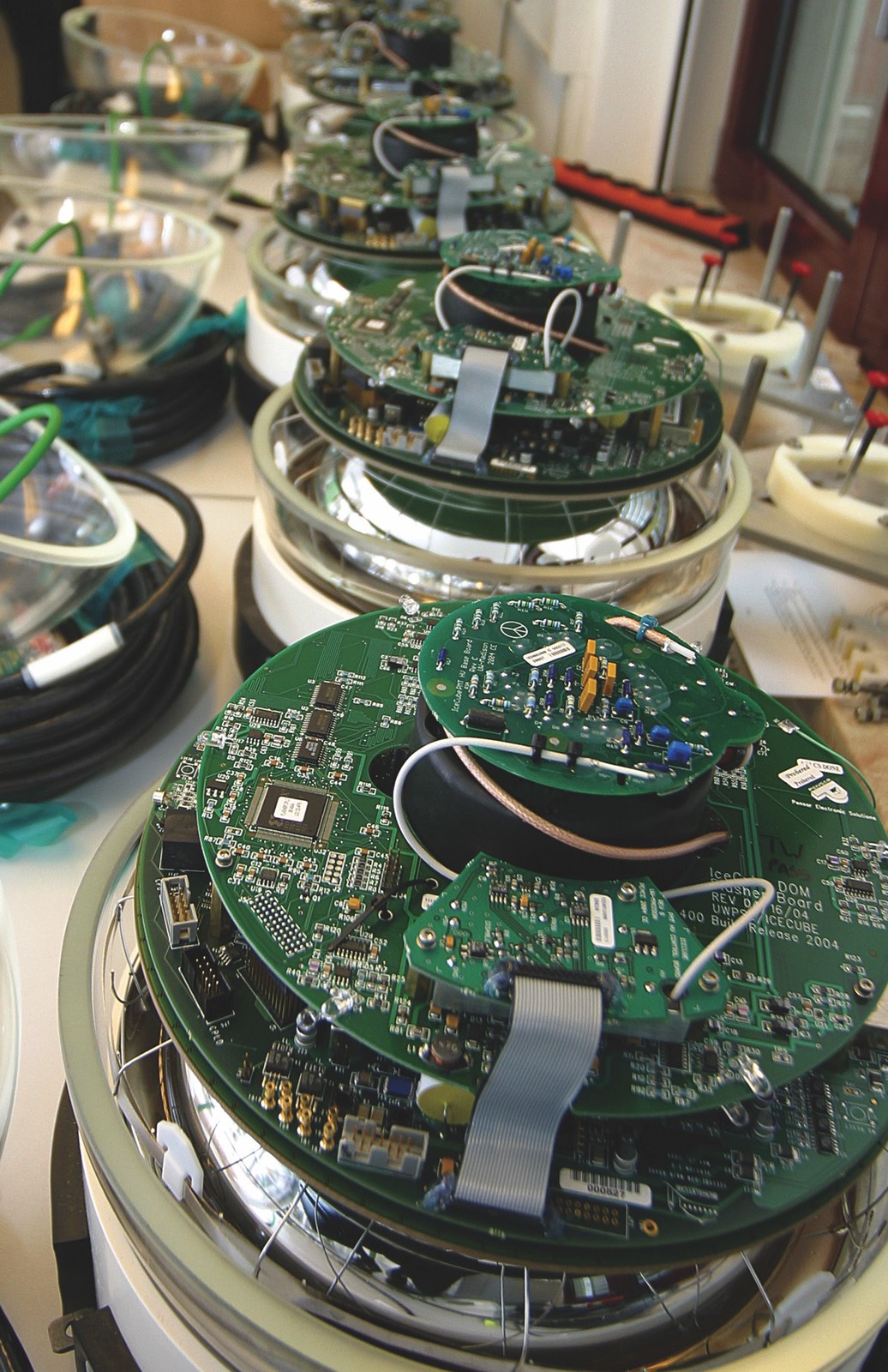 DOMs ready for testing before being shipped to the South Pole. I worked on spare modules at DESY-Zeuthen (not pictured).