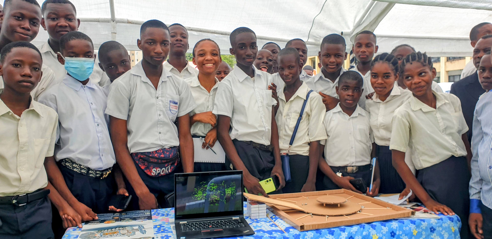 One of the 500 schools visiting the Village of Sciences and attentively listening to my speech on subatomic physics at the CERN and ATLAS booth (with a DIY cardboard scattering demonstrator on the right).